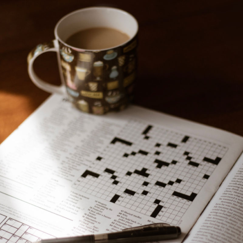 A mug and crossword puzzle